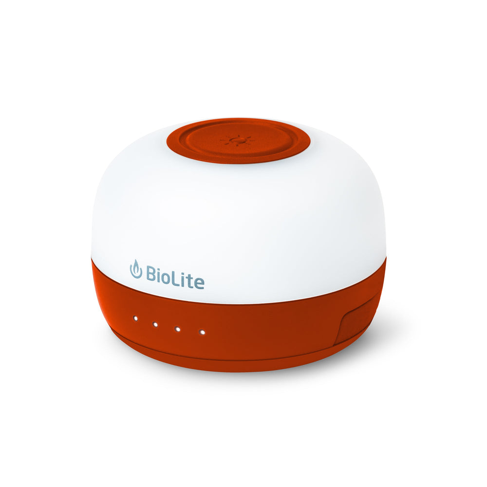 Compact red and white LED lantern on a white background