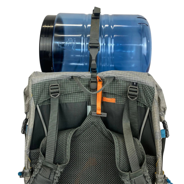 Backpack with a large blue cylindrical bear canister strapped to the back