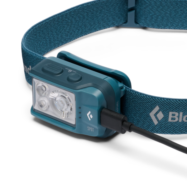 A teal headlamp with a matching fabric headband, shown on a clean white background. The headband features the logo for Black Diamond.