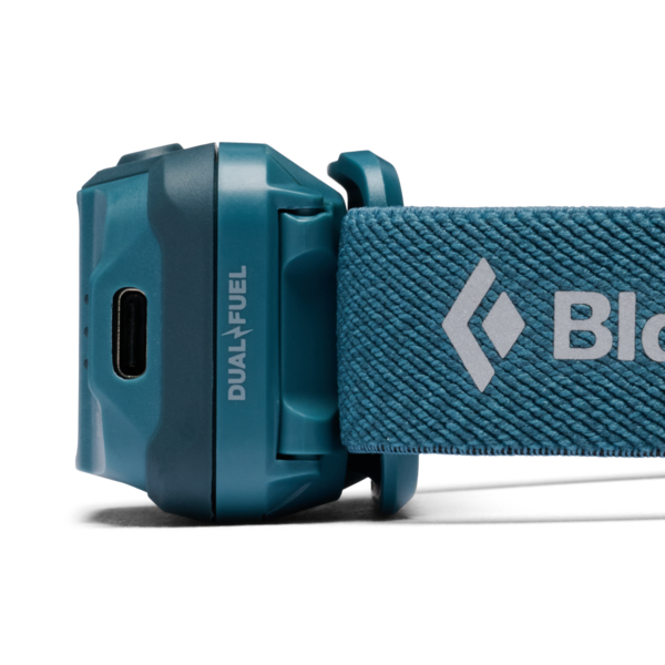 Close-up of a teal headlamp showing the side of the battery pack with a USB-C port and the brand name DUALFUEL, connected to a textured teal headlamp strap with a white logo and partial brand name.