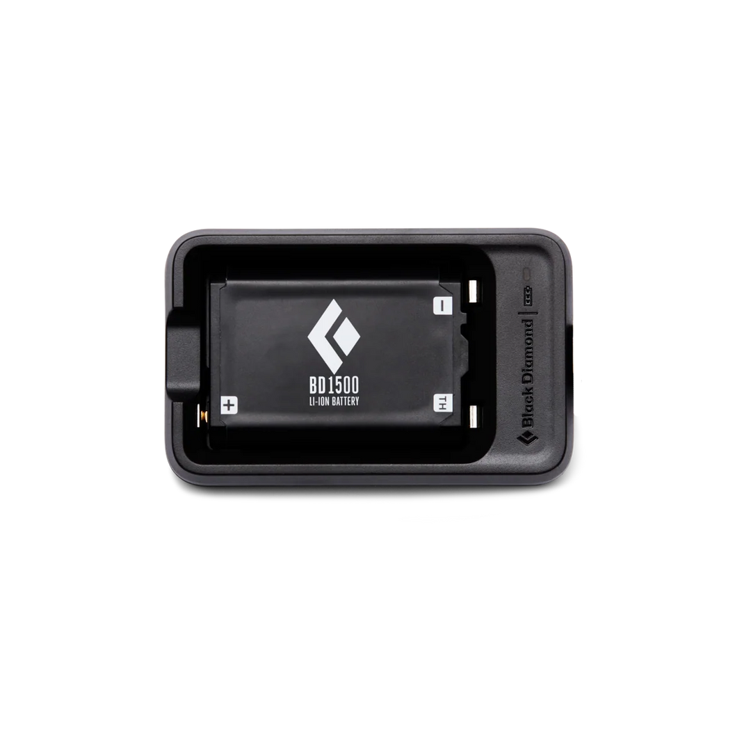 A Black Diamond cap 1500 Li-ion battery shown inside its black charging dock on a clean white background.