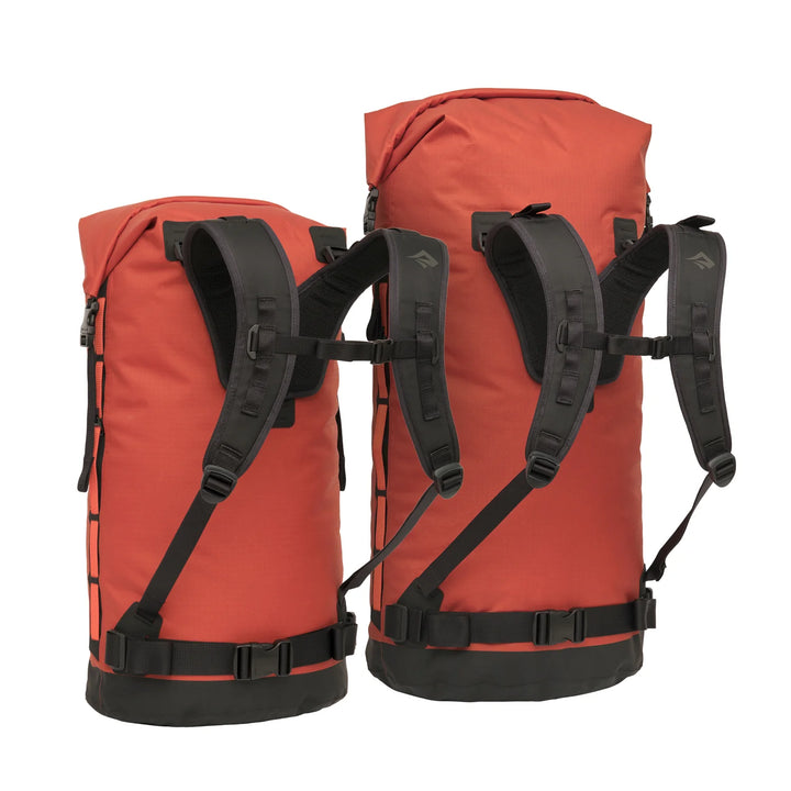 Two red backpacks with black straps on a white background