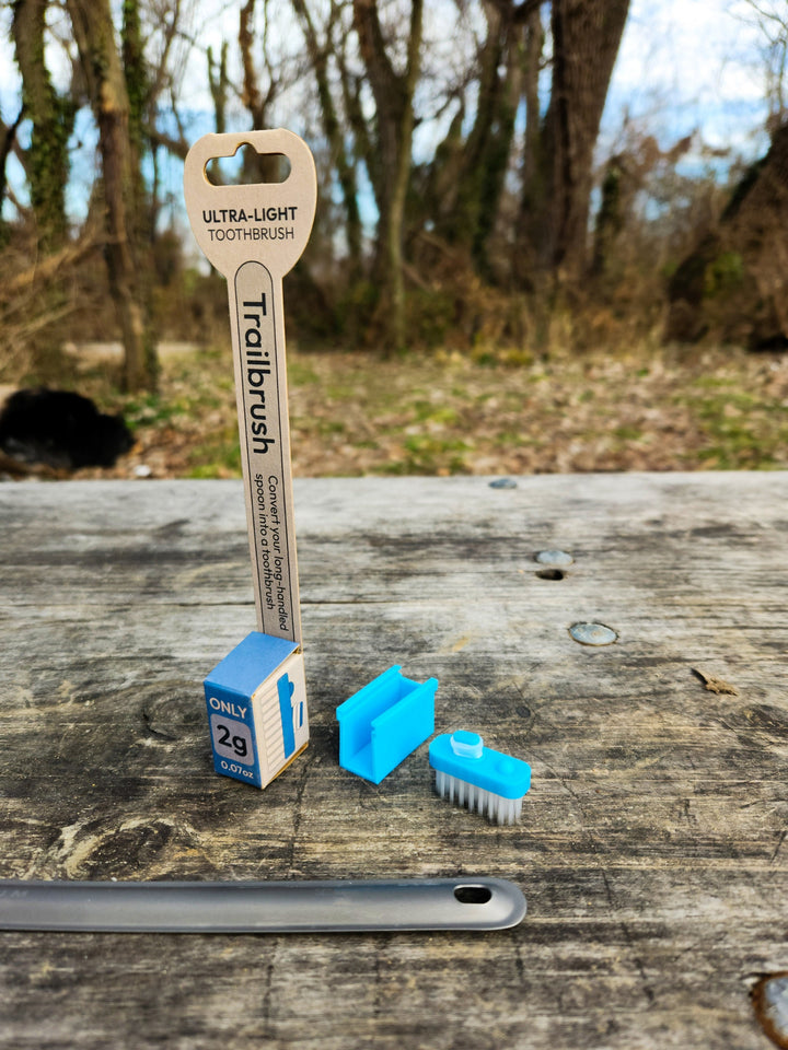 Blue toothbrush head and packaging with a natural background