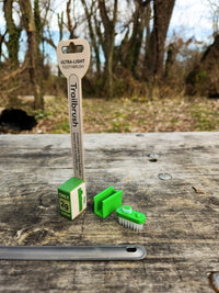 Green toothbrush head and packaging with a natural background