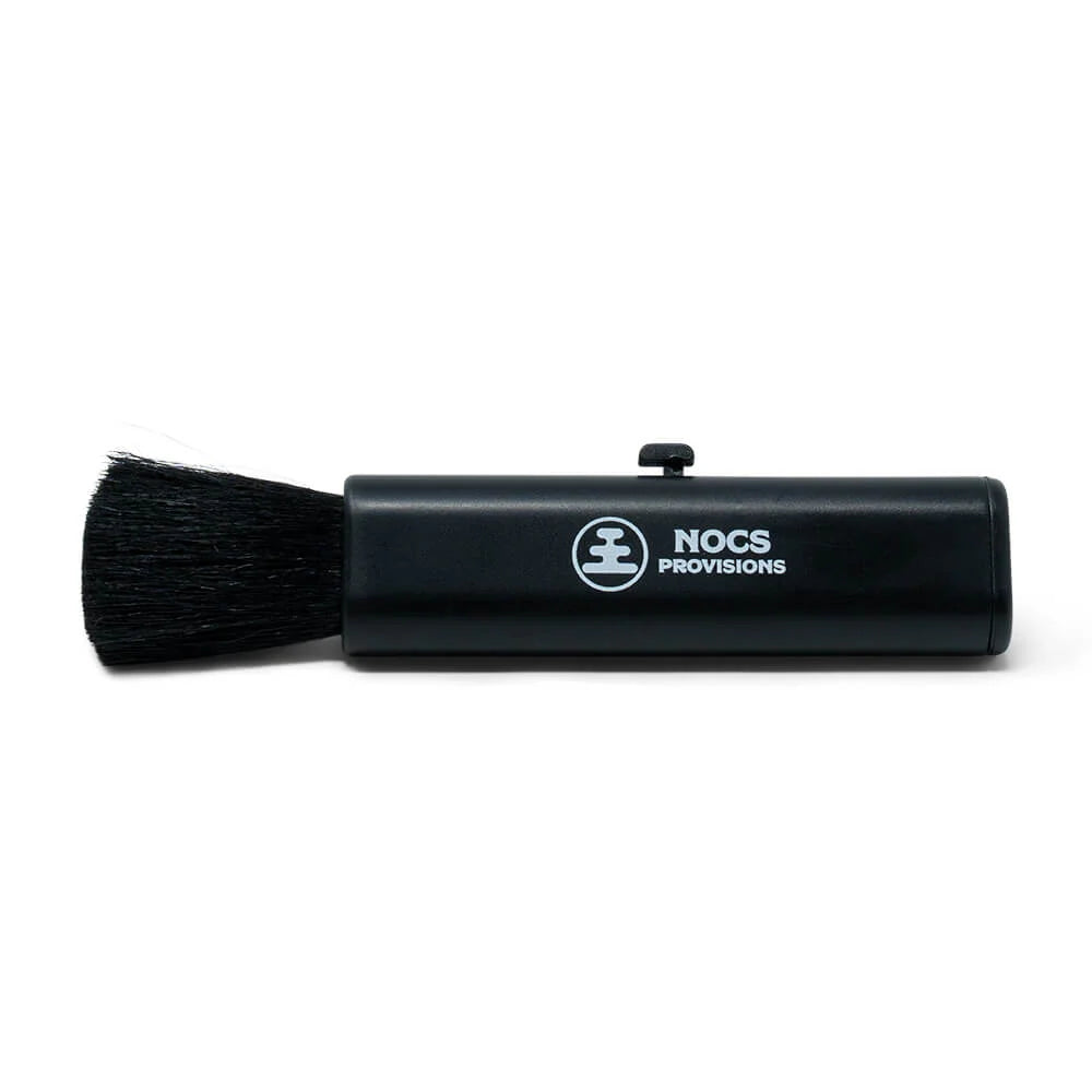 Black short handled brush with Nocs Provisions logo