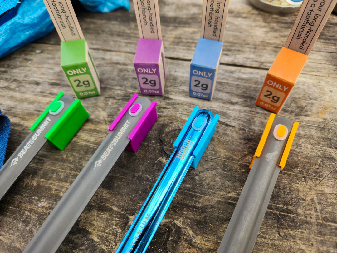 A colourful selection of metal spoons with clip on tooth brush heads