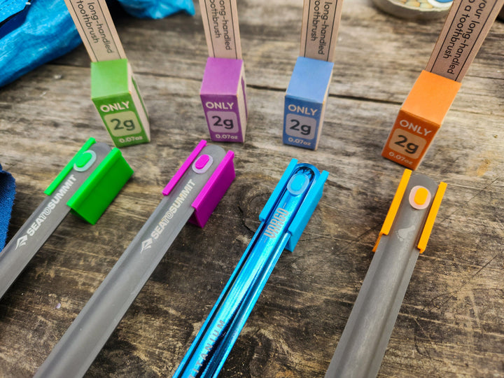 A colourful selection of metal spoons with clip on tooth brush heads