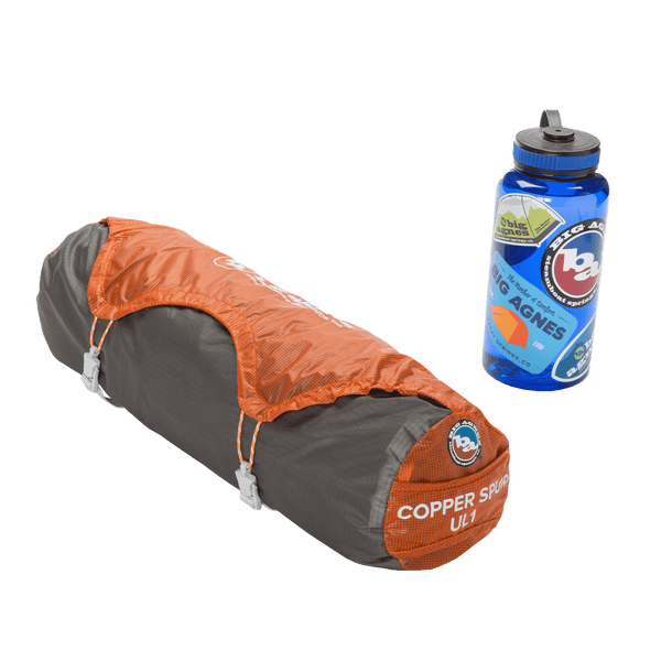 Grey and orange tent stuff sack with a blue 1L bottle with Big Agnes Stickers