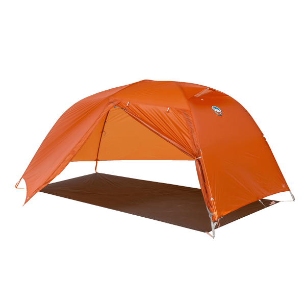Orange hiking tent fly pitched on a grey footprint without the inner