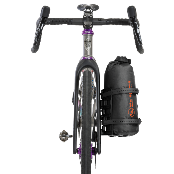 Bicycle with drop bars and a black stuff sack with Big Agnes logo strapped to the fork