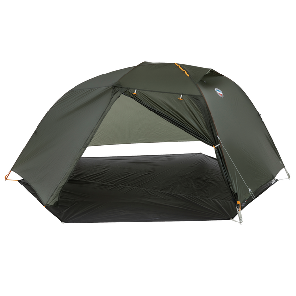 Green hiking tent fly pitched on a grey footprint without the inner tent