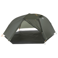 Green hiking tent fly pitched on a grey footprint without the inner