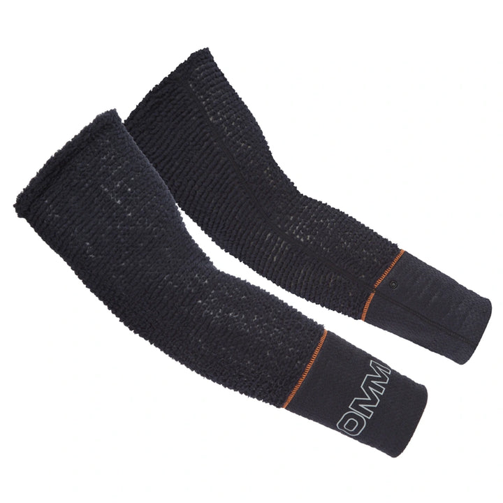 OMM Core Arm Warmers in Black, worn on the forearm showing the stretch fleece fit