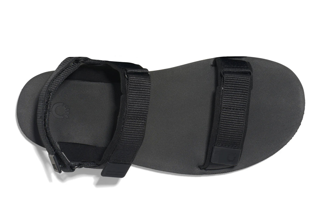 Black sandal with strap on a white background