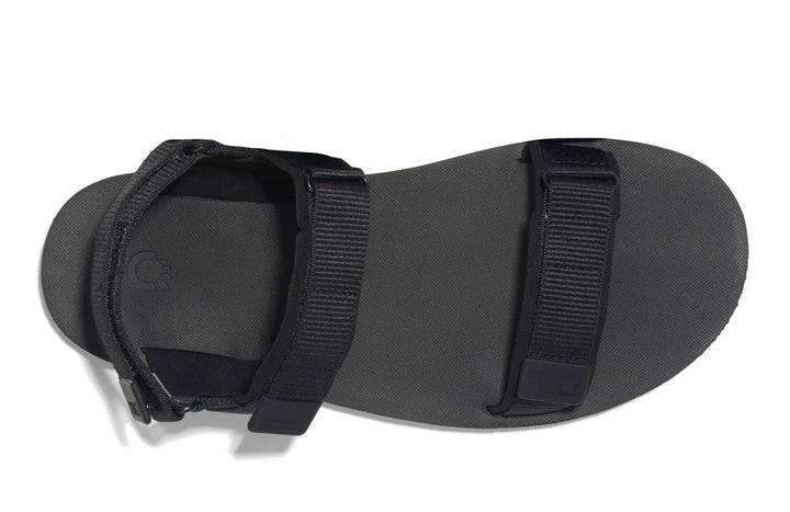 Black sandal with strap on a white background