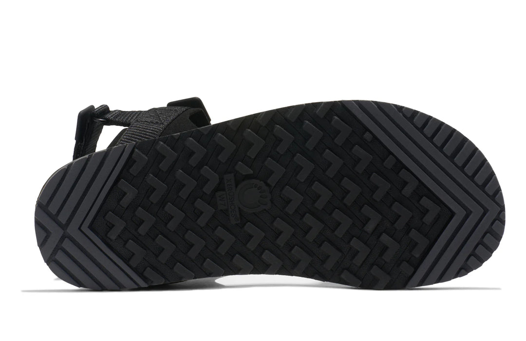 Black sandal with textured sole on a white background
