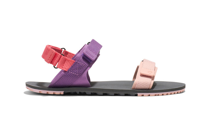 Purple and pink sandal with a black sole on a white background
