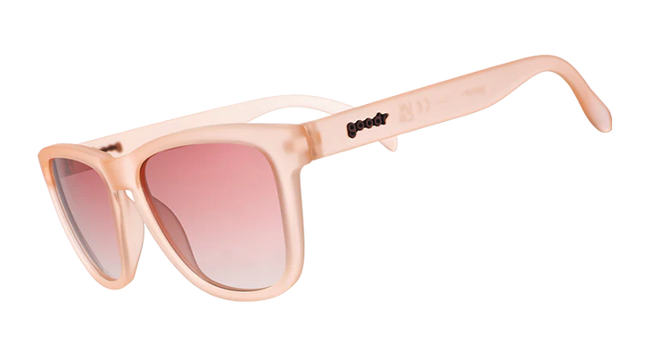 Pink sunglasses with a gradient lens on a white background