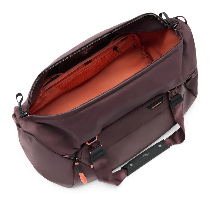 Brown travel bag with open lid on a white background