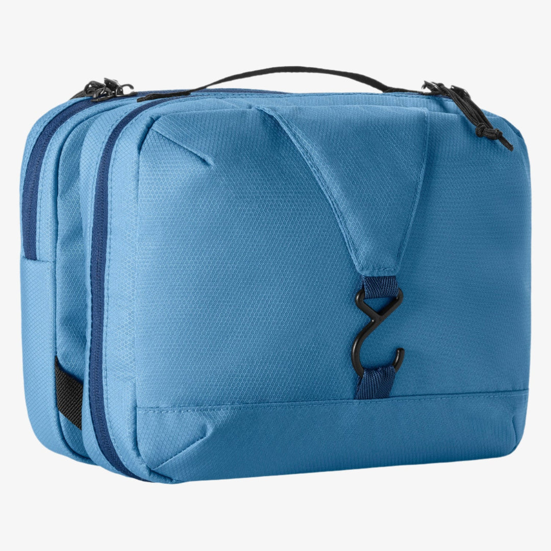 Blue toiletry bag with hook and zippers on a white background