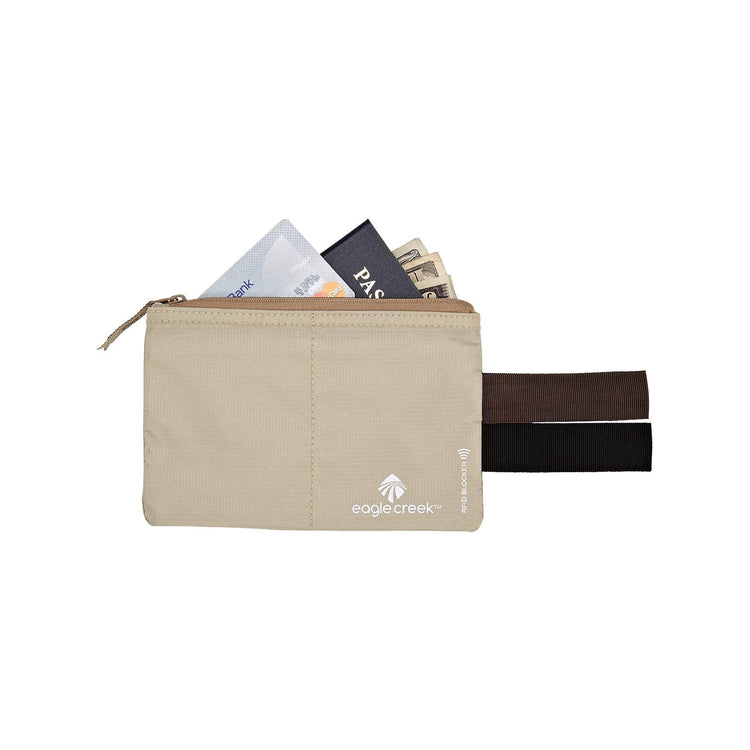 A beige zippered travel pouch with elastic side straps, shown open with cards and a passport sticking out. The Eagle Creek brand logo is printed on the front, set against a plain white background.