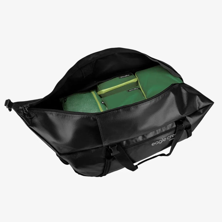 Black duffel bag with a green packing cube inside on a white background