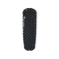 Black inflatable sleeping mat with a mummy shape on a white background
