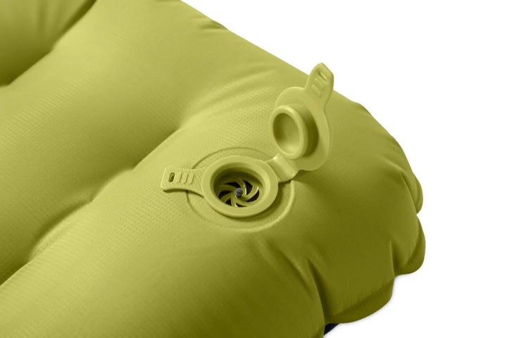 Green inflatable sleeping mat with valve on a white background