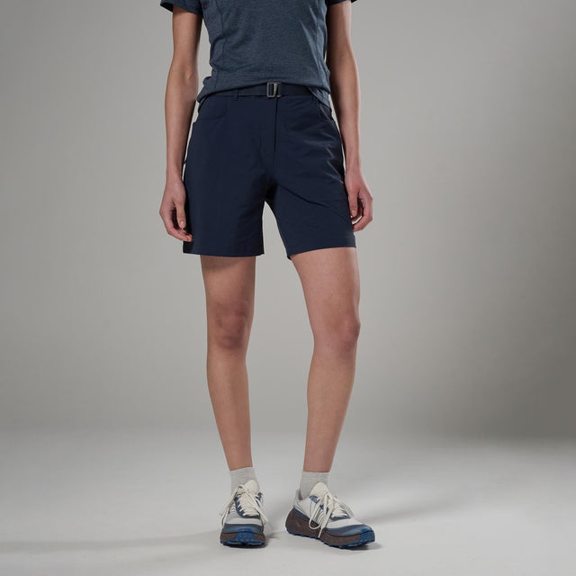 Person wearing navy shorts and a dark shirt on a grey background