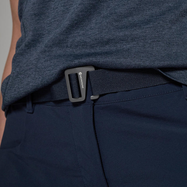 Person wearing navy shorts with a b belt featuring a brand logo navy