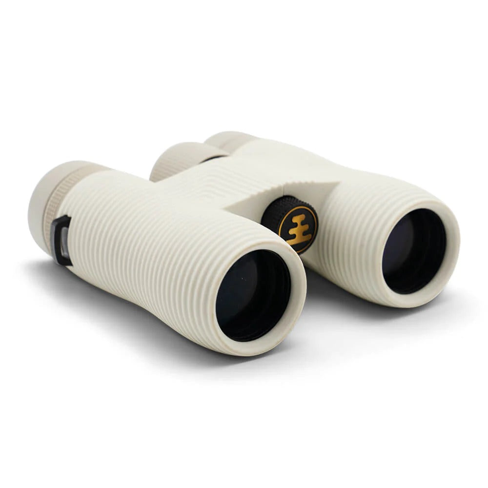 Compact white binoculars with Nocs Provisions logo on a white background