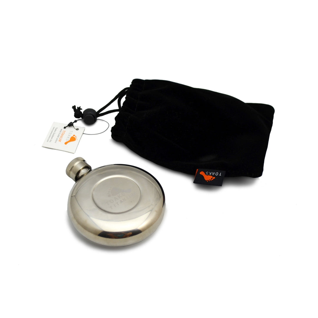 Round silver flask with the Toaks logo and a black carry sack
