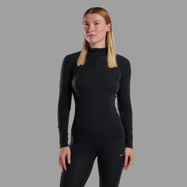 Woman wearing a black long-sleeve athletic top on a grey background