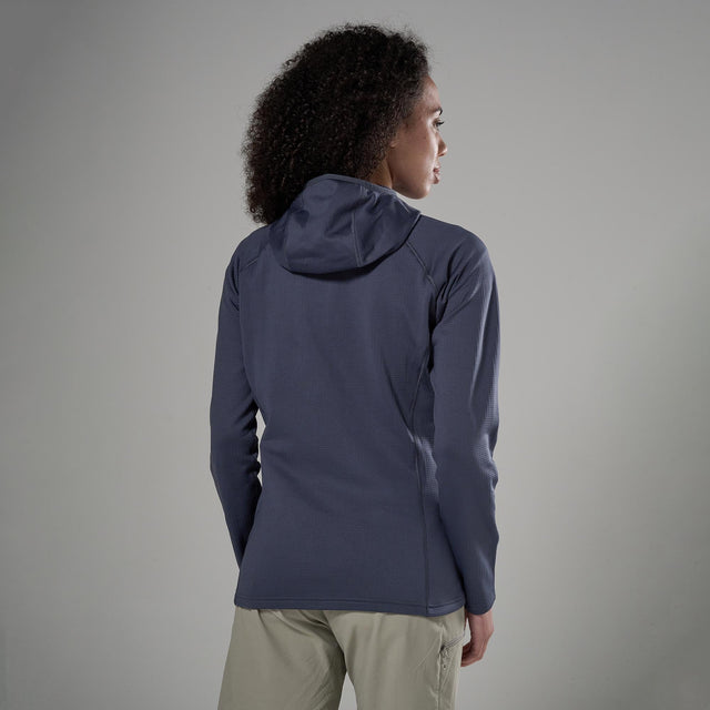 Person wearing a dark blue jacket on a grey background