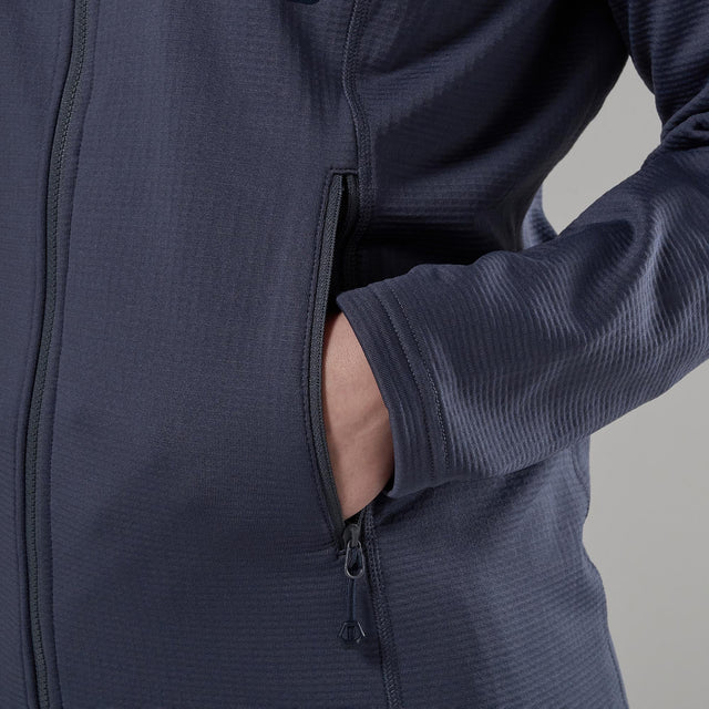 Close up of a hand in zip pocket of a navy blue jacket a grey background