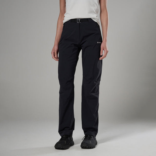 Person wearing black pants on a grey background