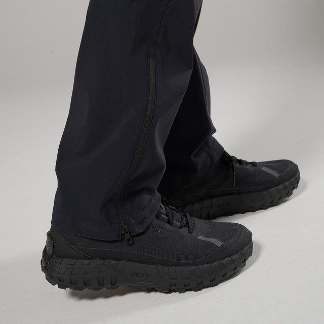 Black boots and pants on a neutral background