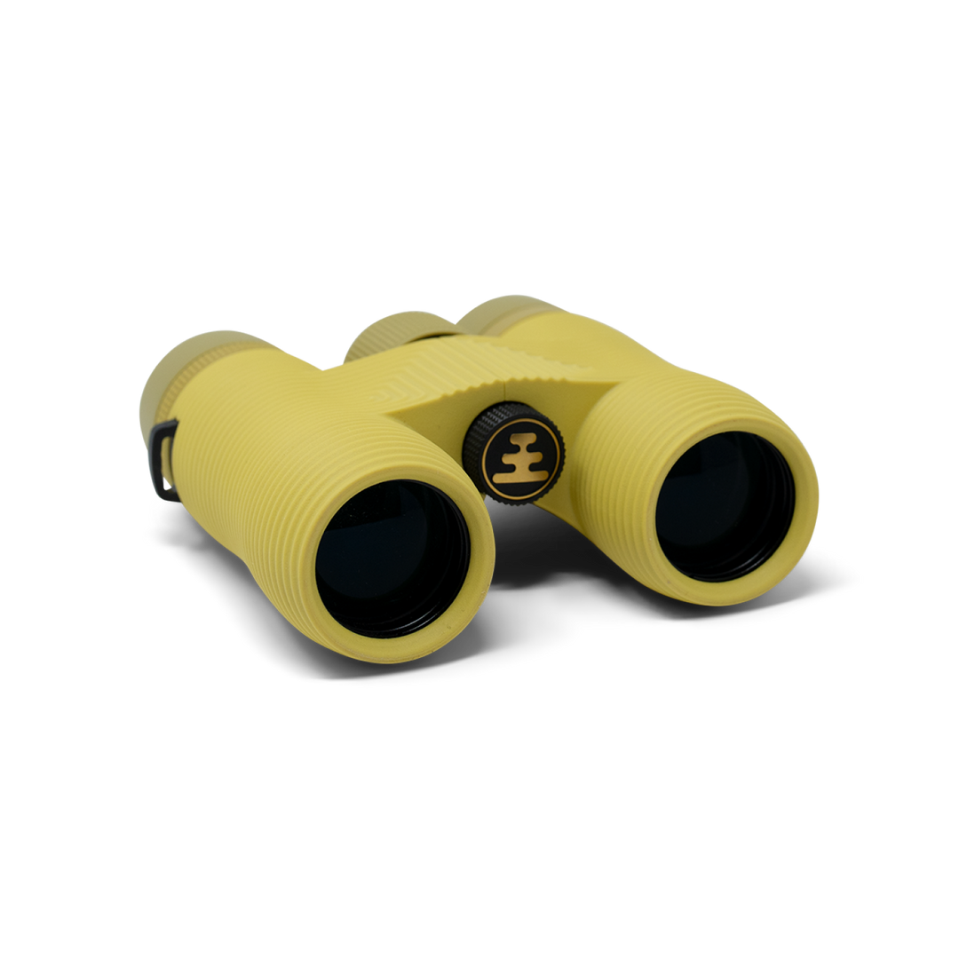 Compact yellow binoculars with Nocs Provisions logo on a white background