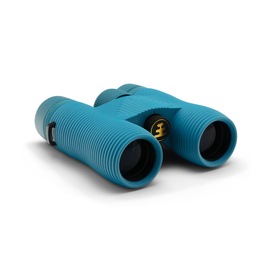 Compact blue binoculars with Nocs Provisions logo on a white background