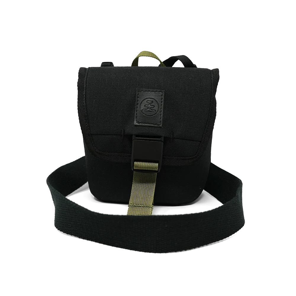 A black tactical shoulder bag with an olive green webbing strap and a black rubber buckle, shown against a plain white background.