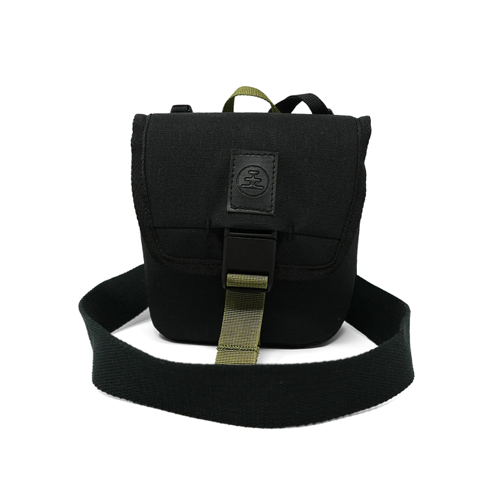 A black tactical shoulder bag with an olive green webbing strap and a black rubber buckle, shown against a plain white background.