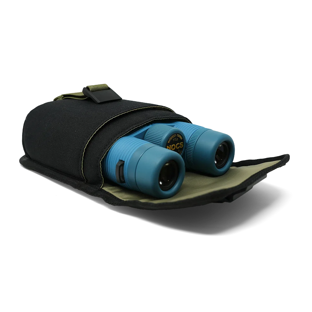 Blue binoculars partially tucked into a black nylon carrying pouch with olive green trim, photographed on a clean white background.