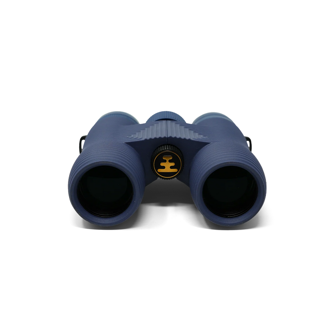 A pair of binoculars in a dark navy blue color, featuring a central circular logo with a yellow crown symbol, photographed against a clean white background.