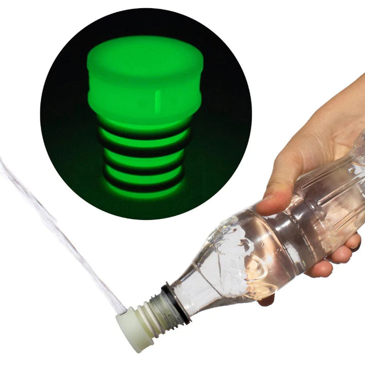 Glow in the dark portable bidet screwed onto a plastic bottle and squirting water
