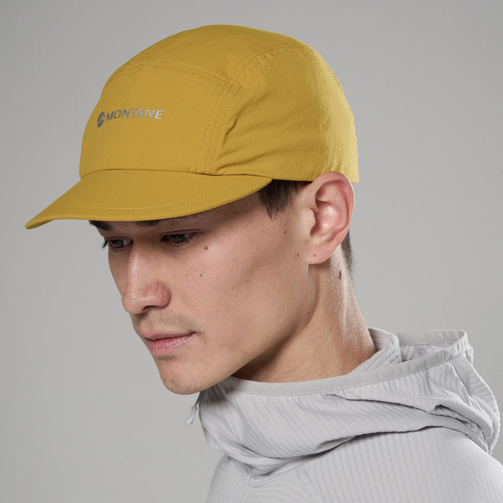 Person wearing a mustard yellow cap with &