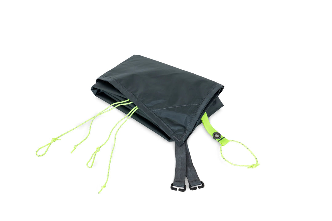 Black tarp with green straps on a white background