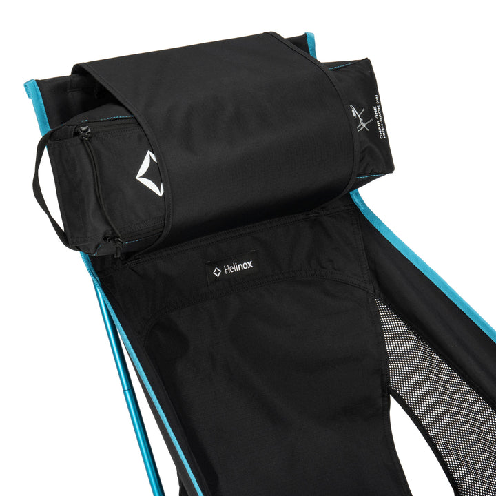 Black camping chair with blue accents and Helinox logo on a white background