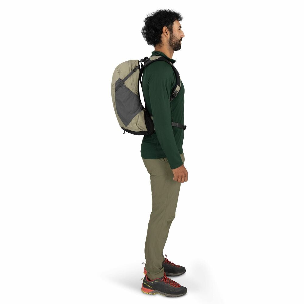 Man wearing a beige backpack on a white background