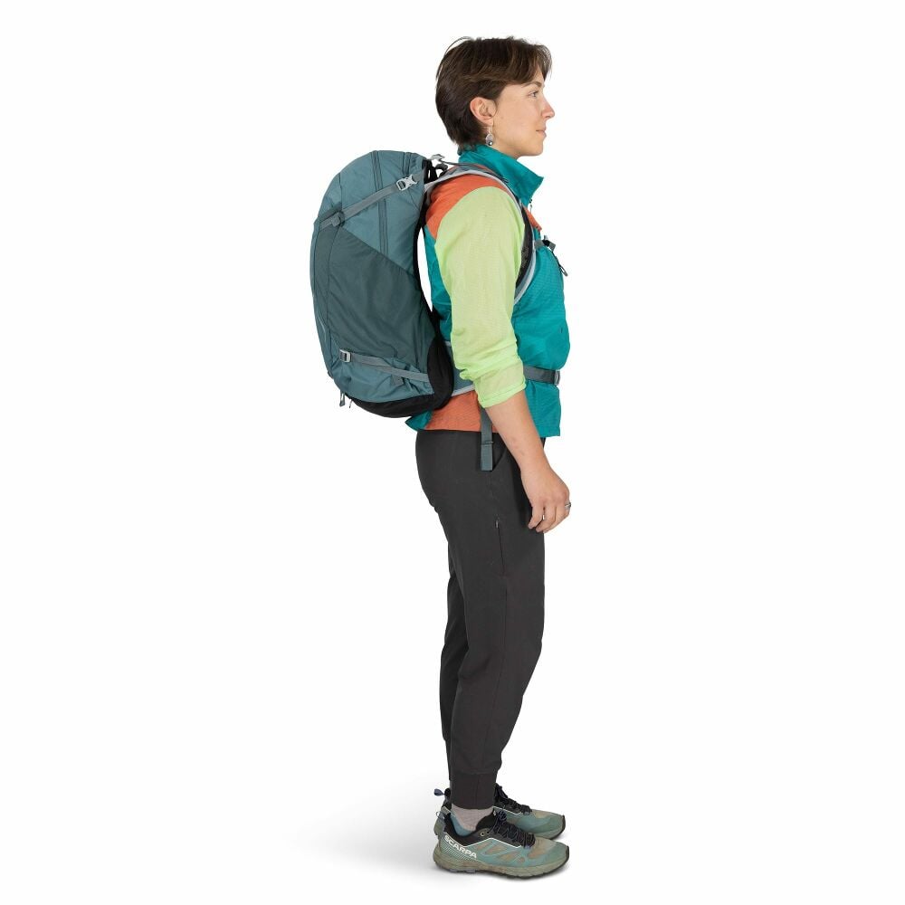 Person wearing a teal backpack on a white background