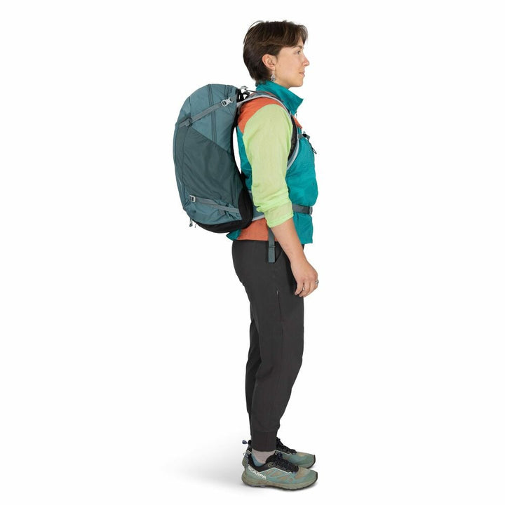 Person wearing a teal backpack on a white background